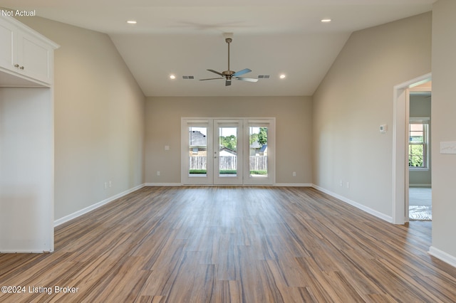 spare room with lofted ceiling, wood-type flooring, and a wealth of natural light