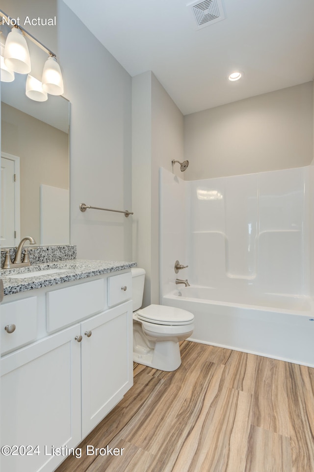 full bathroom featuring shower / tub combination, hardwood / wood-style flooring, vanity, and toilet