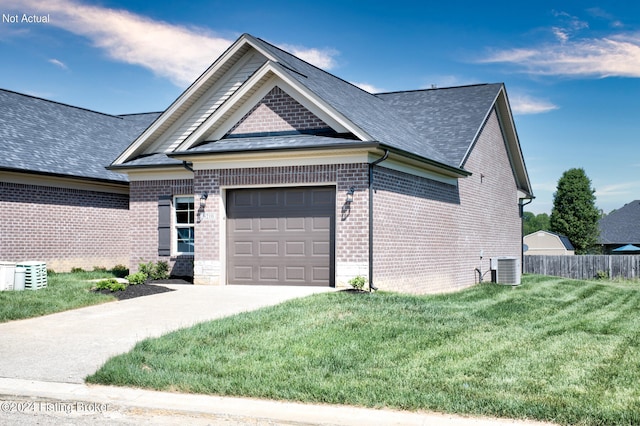 view of front of property featuring cooling unit, a garage, and a front lawn