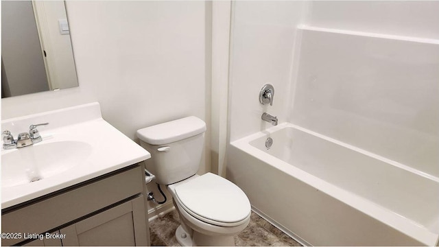 bathroom featuring toilet, vanity, and bathing tub / shower combination