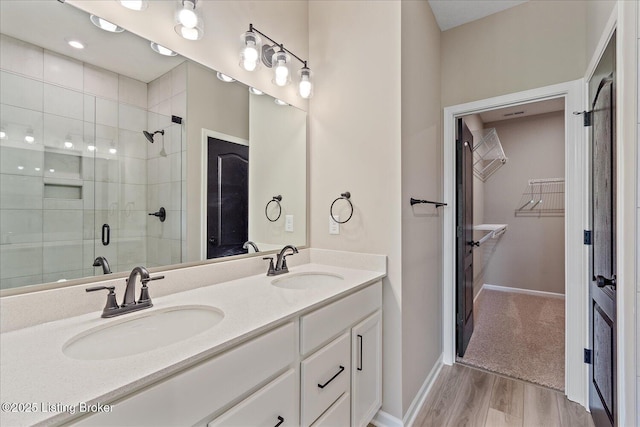 204 Harvest Moon Ct Unit 217B, Shepherdsville, KY 40165 - full bath with a walk in closet, a shower stall, wood finished floors, double vanity, and baseboards