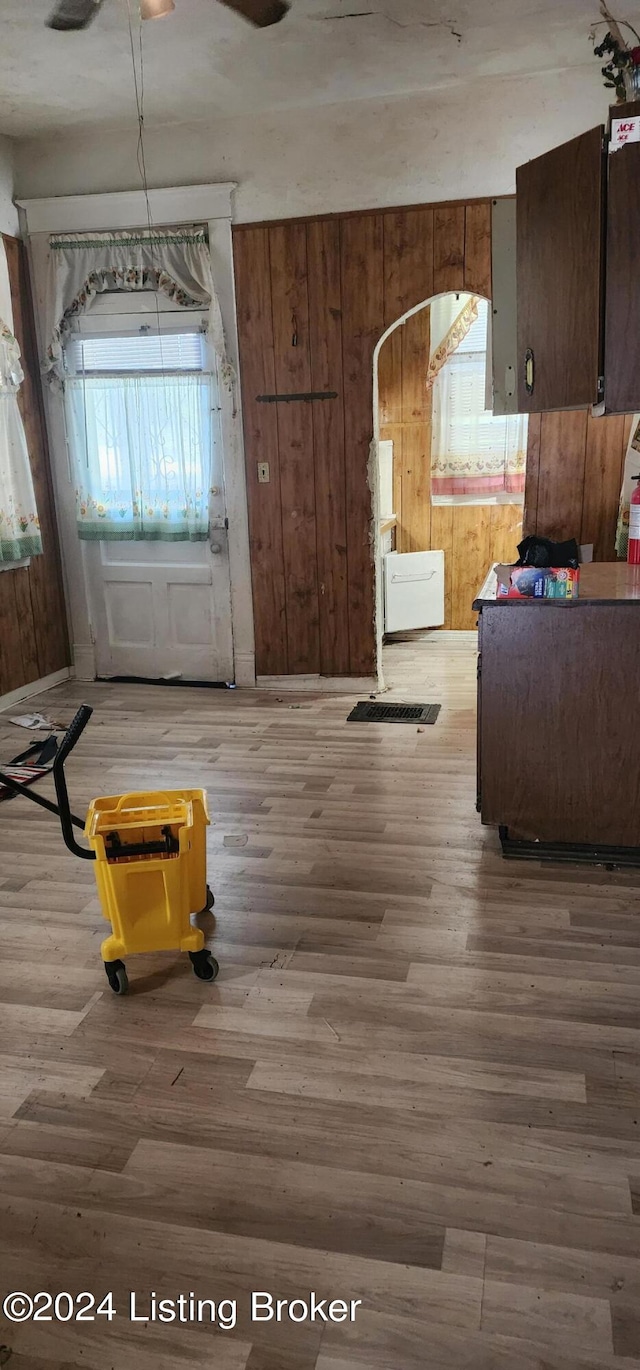 interior space with wood-type flooring and wood walls