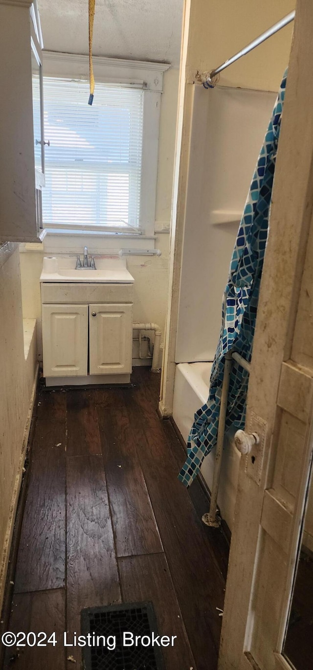 bathroom with vanity, hardwood / wood-style floors, and shower / bath combo