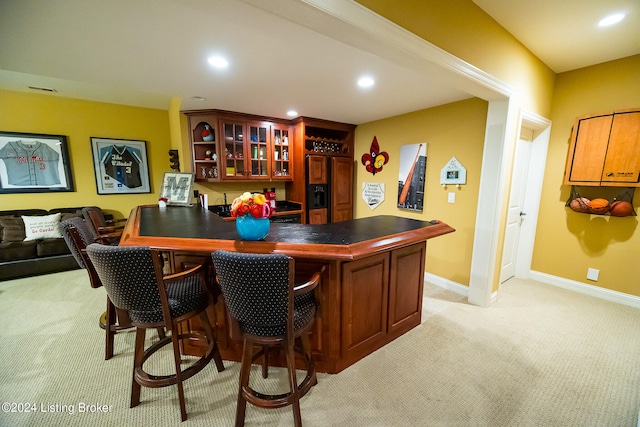 bar with light colored carpet and paneled refrigerator