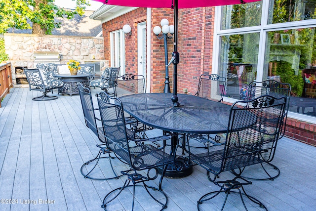 wooden deck featuring a grill