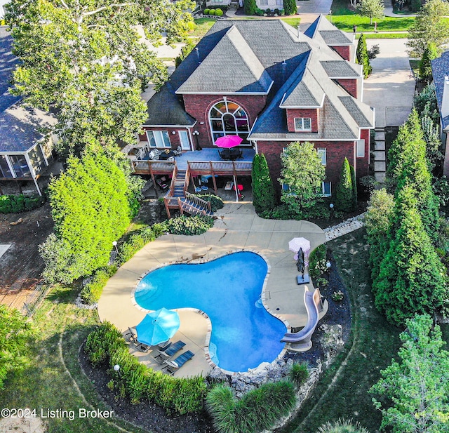 exterior space featuring a patio, a water slide, and a wooden deck