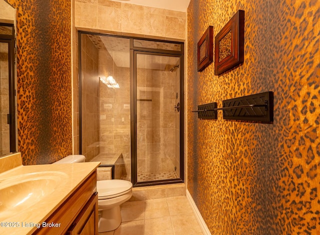 bathroom featuring tile patterned floors, vanity, an enclosed shower, and toilet