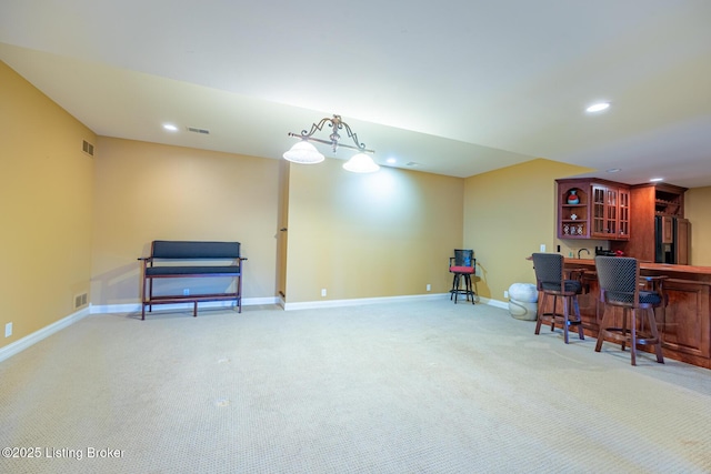 miscellaneous room featuring carpet floors and bar area