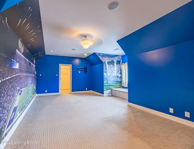 additional living space featuring light carpet, ceiling fan, and vaulted ceiling