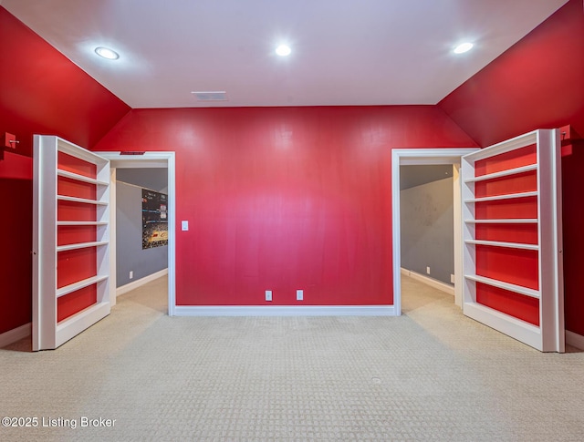 interior space with carpet flooring and lofted ceiling