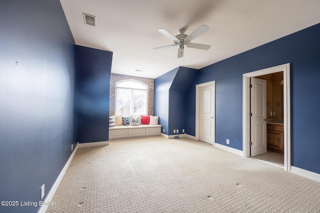 unfurnished bedroom featuring light carpet, ensuite bathroom, and ceiling fan