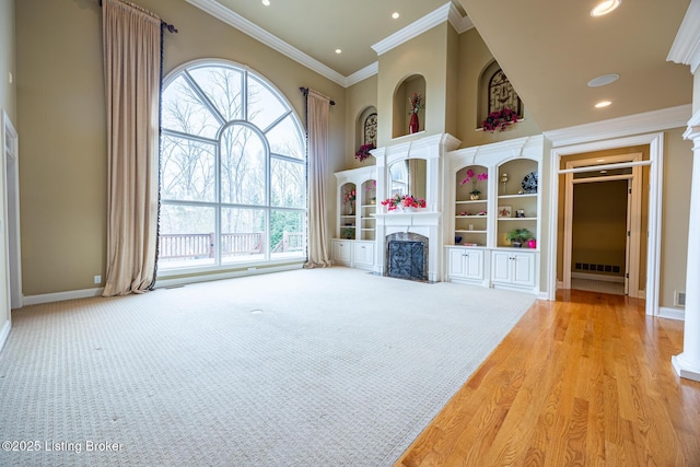 unfurnished living room with light carpet and ornamental molding