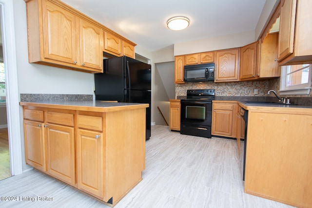 kitchen featuring backsplash, sink, and black appliances