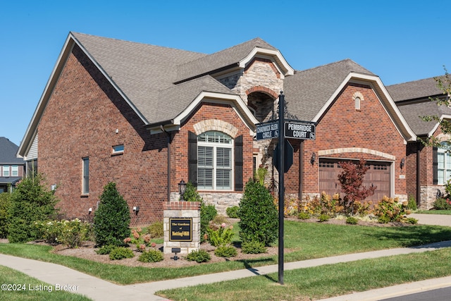 view of front of property featuring a garage and a front yard