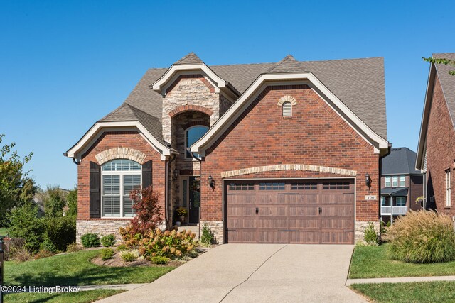 view of front of house featuring a front yard and a garage