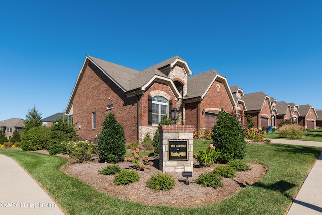 view of front of property with a garage and a front yard