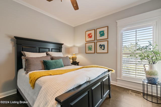 bedroom with ceiling fan, ornamental molding, and dark wood-type flooring