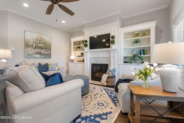 living room with ornamental molding, a fireplace, and ceiling fan