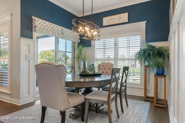 dining area with dark wood-type flooring, crown molding, and a wealth of natural light