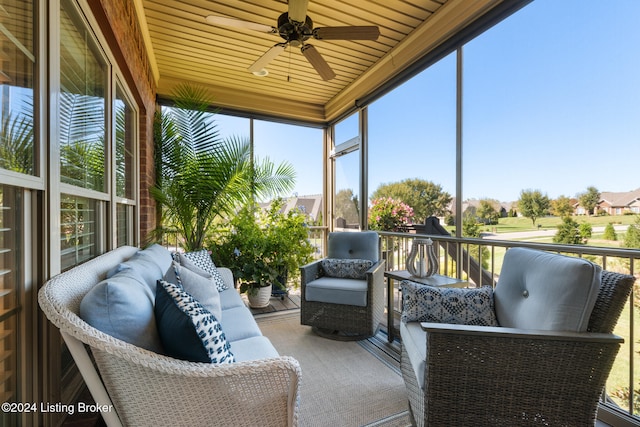 sunroom featuring plenty of natural light, wood ceiling, and ceiling fan