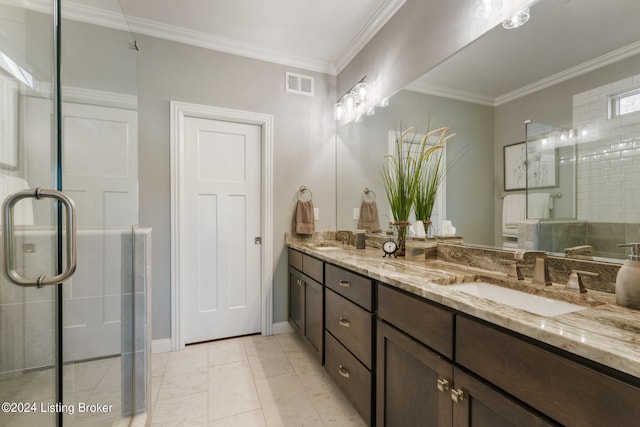 bathroom featuring tile patterned flooring, crown molding, a shower with door, and vanity