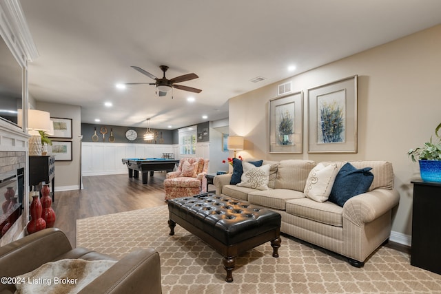 living room with a brick fireplace, billiards, light wood-type flooring, and ceiling fan