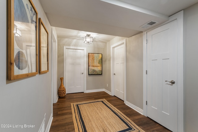 corridor with dark hardwood / wood-style floors