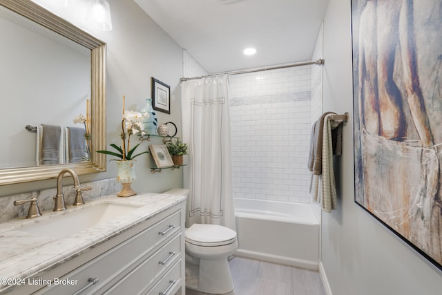 full bathroom featuring vanity, shower / tub combo, and toilet