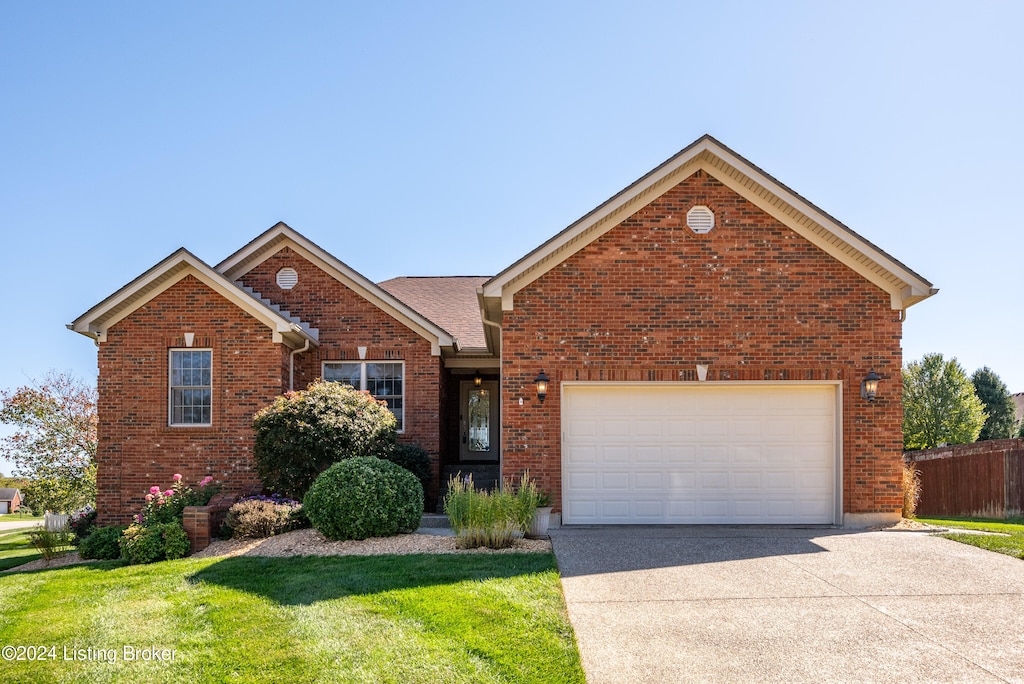 front of property featuring a front yard and a garage