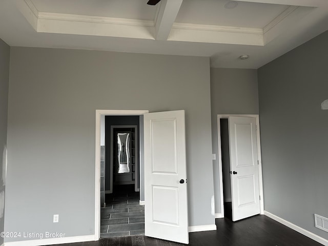 unfurnished bedroom with ornamental molding, beam ceiling, and dark hardwood / wood-style floors