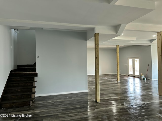 basement with french doors and dark hardwood / wood-style flooring