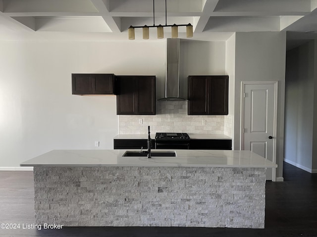 kitchen with dark hardwood / wood-style floors, tasteful backsplash, black gas range oven, wall chimney range hood, and decorative light fixtures