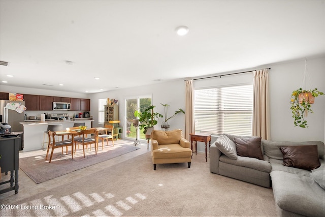 living room featuring light carpet