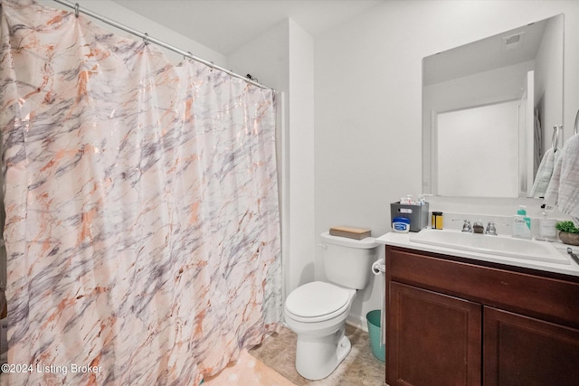 bathroom featuring tile patterned floors, vanity, and toilet