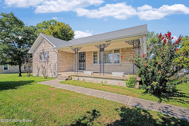 view of front of home with covered porch and a front yard