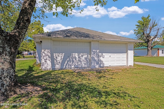 garage featuring a lawn