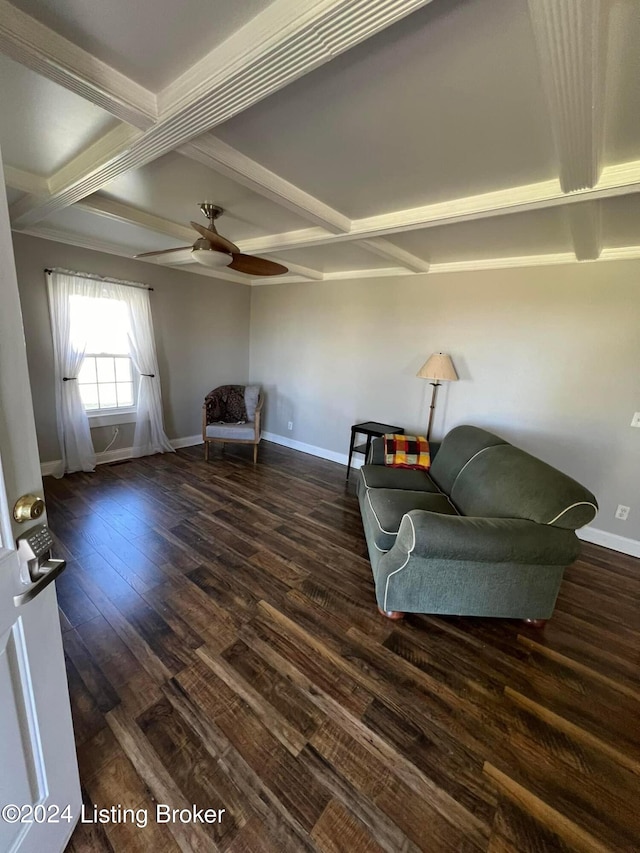 sitting room featuring ceiling fan, dark hardwood / wood-style flooring, and beamed ceiling