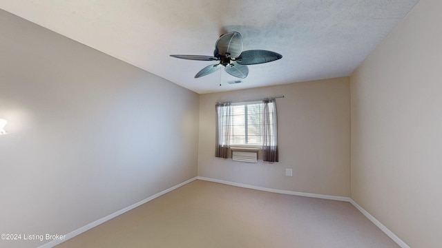 empty room with carpet flooring, ceiling fan, and a textured ceiling