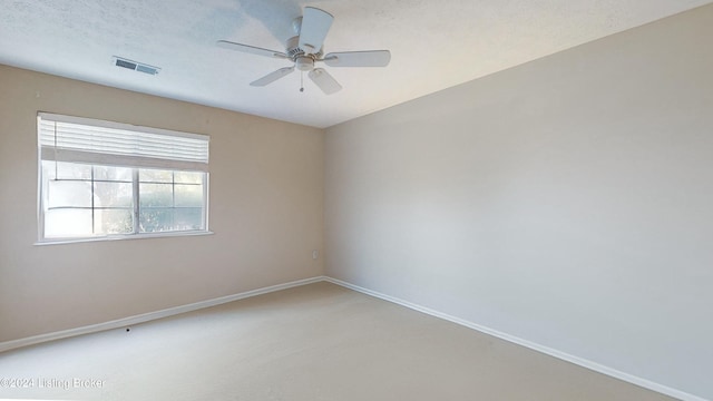 spare room with ceiling fan, carpet floors, and a textured ceiling