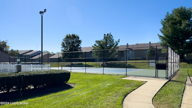 view of sport court featuring a yard