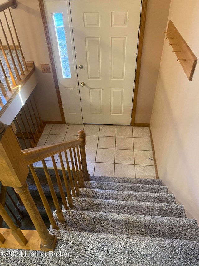 stairway featuring tile patterned floors