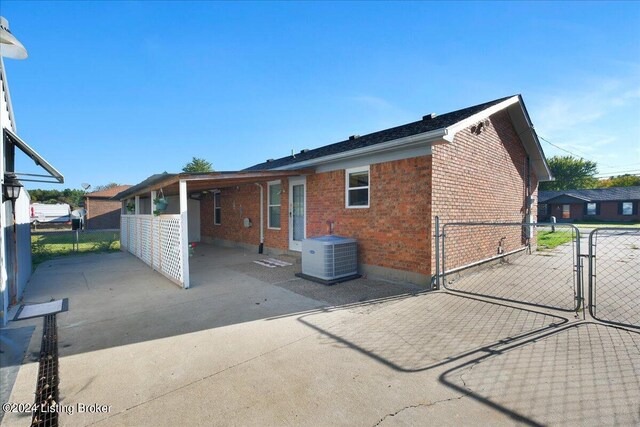 rear view of house with a patio area and central AC