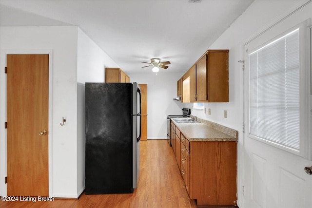 kitchen with stainless steel appliances, light wood-type flooring, and ceiling fan