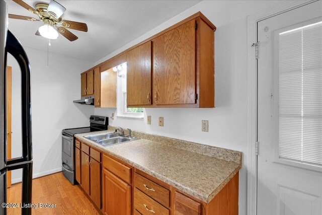 kitchen with light hardwood / wood-style floors, ceiling fan, range hood, sink, and stainless steel electric range oven