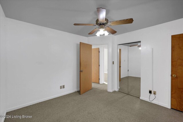 unfurnished bedroom with ceiling fan, light colored carpet, and a closet