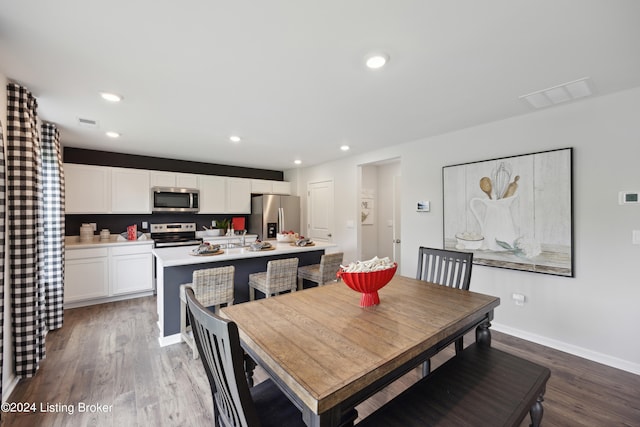 dining space featuring dark wood-type flooring