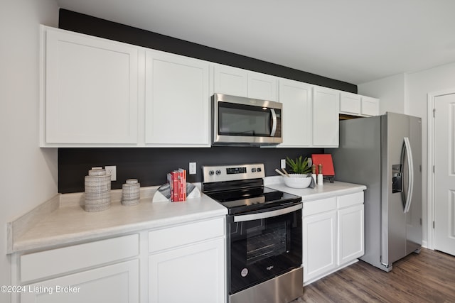 kitchen featuring appliances with stainless steel finishes, white cabinetry, and dark hardwood / wood-style flooring