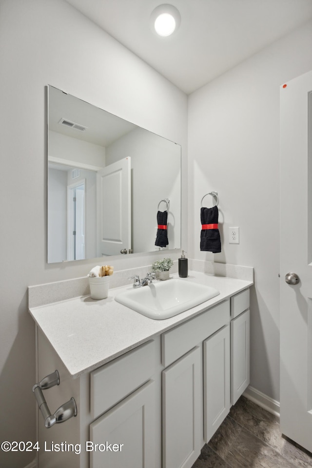 bathroom featuring wood-type flooring and vanity