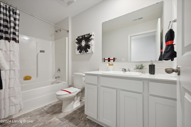 full bathroom featuring shower / bath combination with curtain, vanity, and toilet