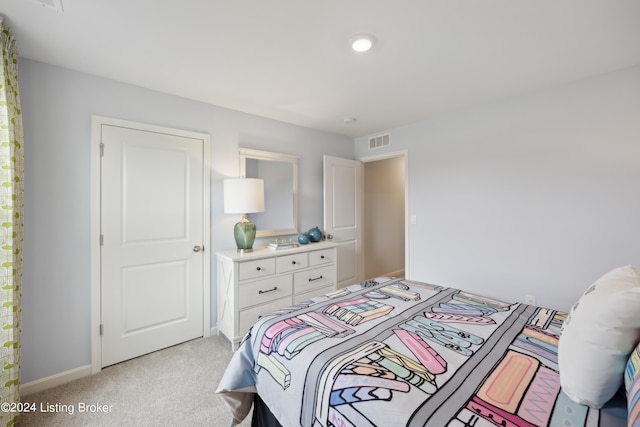 bedroom featuring light colored carpet